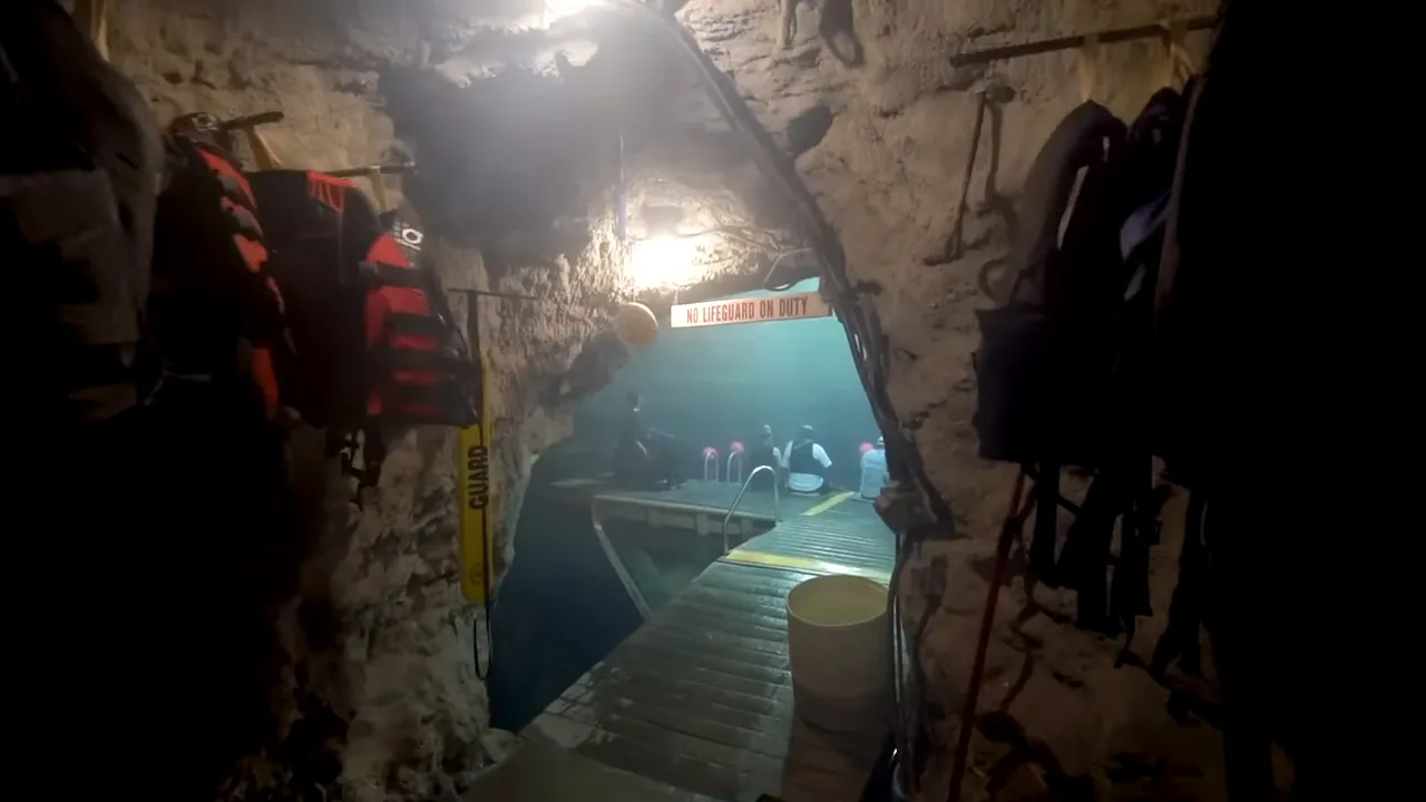 Entrance to geothermal Homestead Crater with cave entry and warm water visible